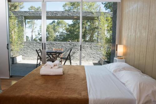 Ένα ή περισσότερα κρεβάτια σε δωμάτιο στο Qi Casas de Río