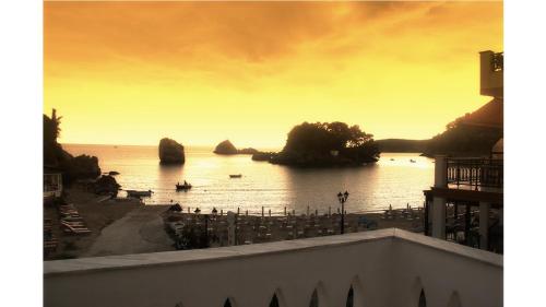 a view of a body of water at sunset at Bakagiannis Apartments in Parga