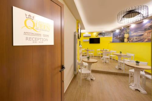 a restaurant with tables and a yellow wall at B&B Sorrento Queen in Sorrento