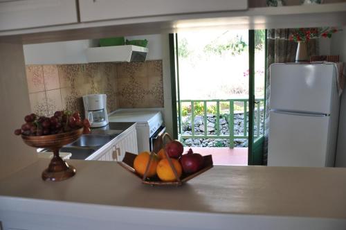 a kitchen with a bowl of fruit on a counter at Bellevue Apartments in Sitia