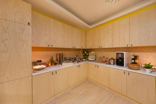 a large kitchen with wooden cabinets and appliances at B&B Sorrento Queen in Sorrento