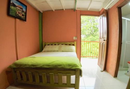 a bedroom with a bed in the corner of a room at Cabañas Ecoturisticas Y Club Gaira Tayrona in Santa Marta