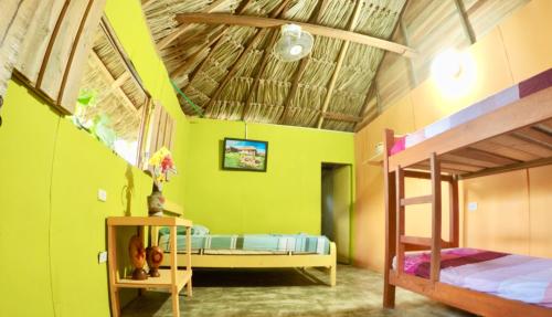 a bedroom with two bunk beds in a room at Cabañas Ecoturisticas Y Club Gaira Tayrona in Santa Marta