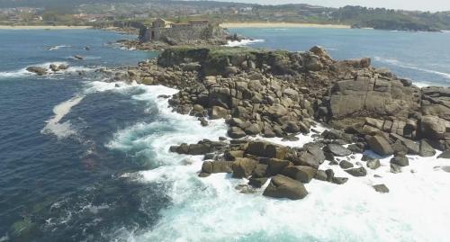an aerial view of a rocky island in the ocean at Hotel Florida in A Lanzada