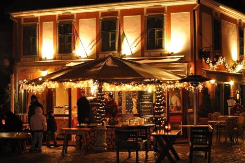a restaurant lit up at night with lights at Senator Ház in Eger