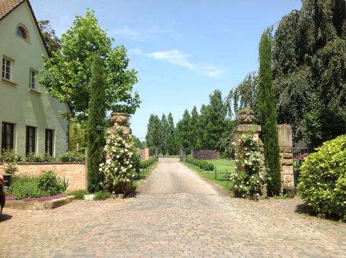 a brick road with flowers in a garden at Hofgut Holzmuhle in Germersheim