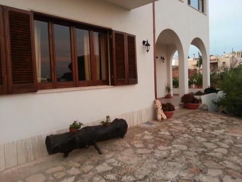 a white building with a bench in front of it at Le Grotte di Notar in Castellana Grotte