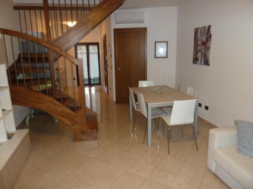 a dining room and living room with a table and chairs at Casa Cuore - Love Pets - Fronte Ospedale Sacro Cuore in Negrar