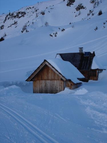 a small wooden building covered in snow on a mountain at Welcome-Bienvenue-Добро пожаловать in Flachau