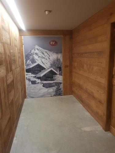 a room with a door with a picture of a mountain at MH Olen Boutique Hotel in Alagna Valsesia