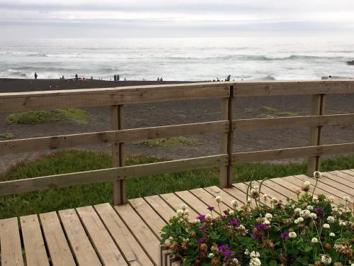 una terrazza in legno con vista sulla spiaggia di Casa Frente al Mar a Pichilemu