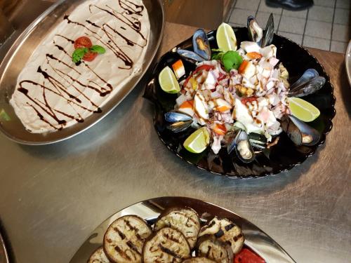 three plates of food on a table with food at Pension – Restaurant Jägerwinkl in Rettenberg