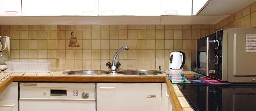 a kitchen with a sink and a microwave at Haus Fless 7 in Klosters Dorf