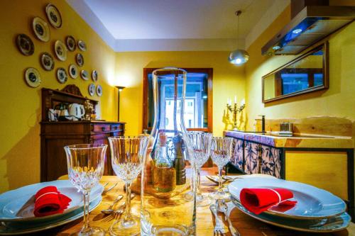 a dining room table with wine glasses and red napkins at Villa Betteloni Valpolicella Suites in San Pietro in Cariano