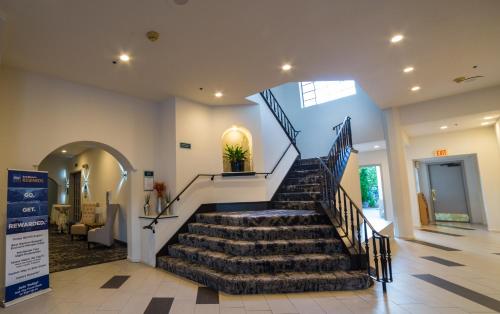 a staircase in a building with a stair case at Best Western Posada Royale Hotel & Suites in Simi Valley