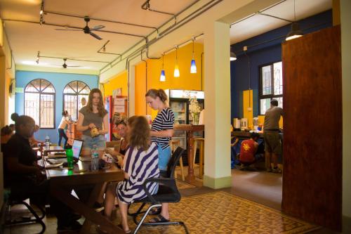 a group of people sitting at a table in a restaurant at Hostel Mamallena in Panama City