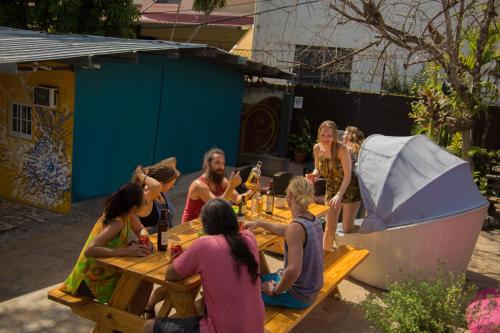 a group of people sitting around a picnic table at Hostel Mamallena in Panama City