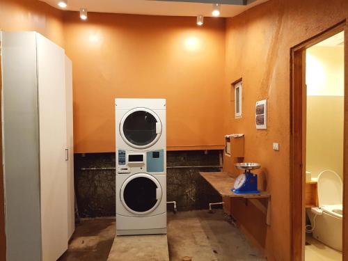 a bathroom with a washer and dryer in it at Stay Amare Villa Maria 2 in Bacolod