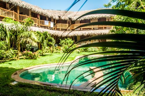 a resort with a swimming pool in front of a building at Residence Bons Ventos Jeri in Jericoacoara