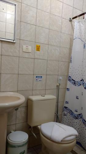 a small bathroom with a toilet and a sink at Pousada Solar das Andorinhas in Fernando de Noronha