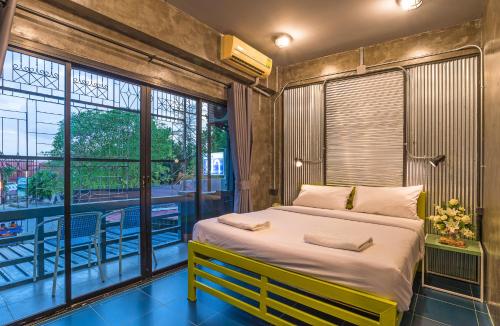 a bedroom with a large bed and a balcony at Sanim Hostel in Ao Nang Beach
