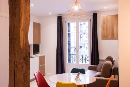 a living room with a table and chairs at Baps Apartaments 2 in Bilbao