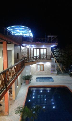 a house with a swimming pool at night at Hotel Mediterraneo in Canoa