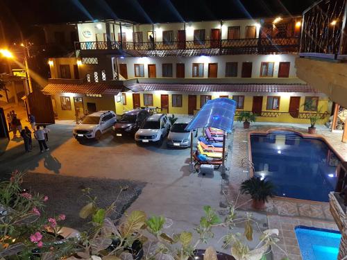 an aerial view of a hotel with cars parked in a parking lot at Hotel Mediterraneo in Canoa