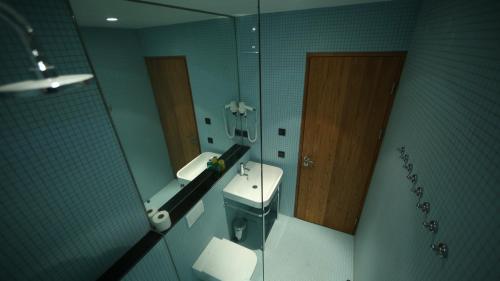 a bathroom with a toilet and a sink and a mirror at Drangar Country Guesthouse in Drangar