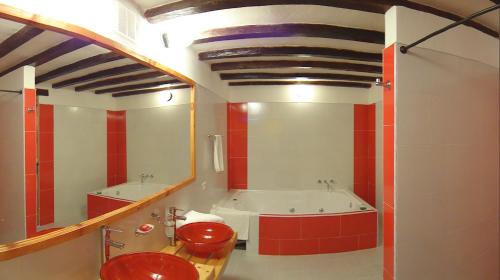 a bathroom with a tub and a sink and a mirror at Hotel Spa Casa de Adobe Villa de Leyva in Villa de Leyva