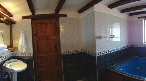 a bathroom with a tub and a sink at Hotel Spa Casa de Adobe Villa de Leyva in Villa de Leyva