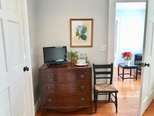 a living room with a television on a dresser at Hudson B&B in Hudson
