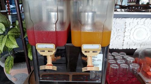 two glass containers filled with different colored liquid at Respati Beach Hotel in Sanur