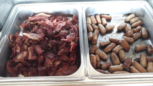 two plastic containers filled with different types of food at Respati Beach Hotel in Sanur
