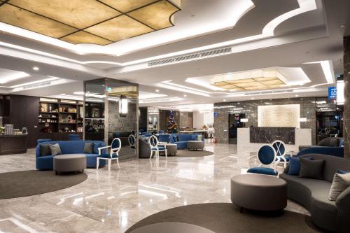 a lobby with couches and chairs in a building at 台南星鑽國際商旅 Hua Hotel in Tainan