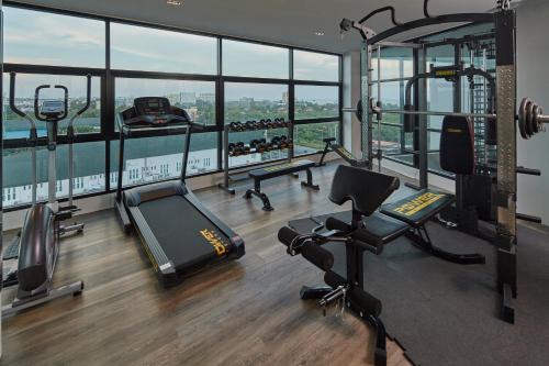 a gym with treadmills and exercise equipment in a building at Whale Hua Hin - SHA Plus in Hua Hin