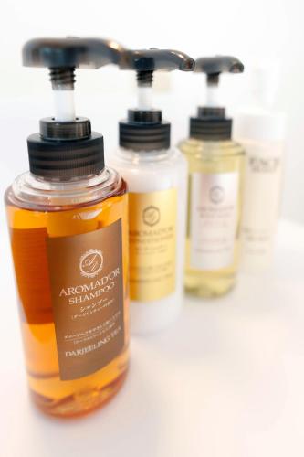 a group of four bottles of honey on a counter at Hotel JIN Morioka Ekimae in Morioka