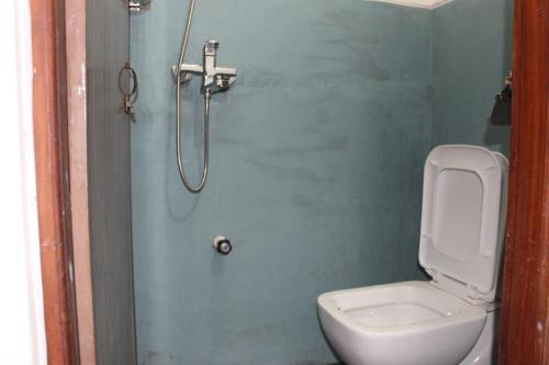 a small bathroom with a toilet and a shower at Natures Bliss Holidays in Ja-Ela
