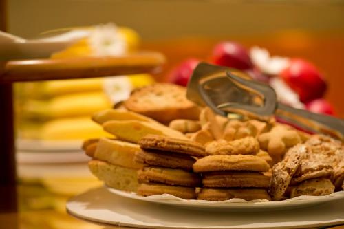 a plate of bread and snacks on a table at Hotel Spadari Al Duomo in Milan