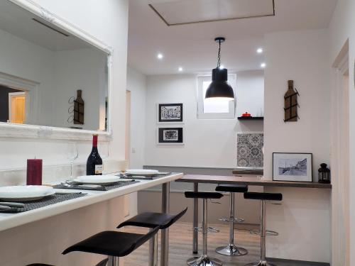 a kitchen with a bar with stools and a counter top at Deluxe Zoya Centar in Pula