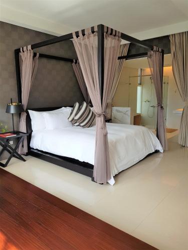 a bedroom with a bed with a canopy at Around The Tree Manor in Shitan