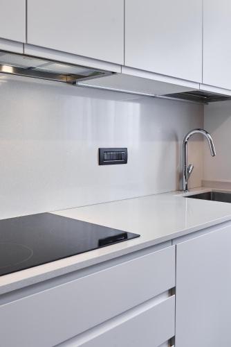 a kitchen with white cabinets and a sink at La Perla by Sedar in Como