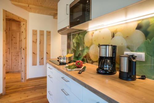 a kitchen with a counter with a coffee maker on it at Hofer Hof in Feldthurns