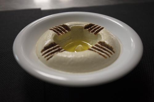 a white plate with a baseball on a table at Hotel Palm Beach in Pointe-Noire