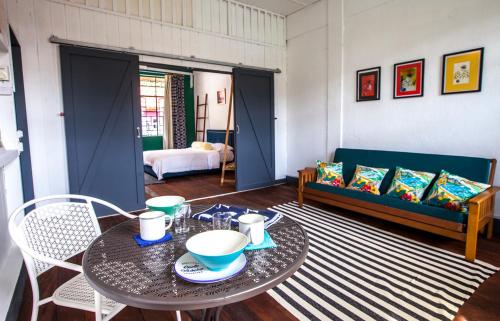 a living room with a table and a couch at The Jungalow in Kota Kinabalu