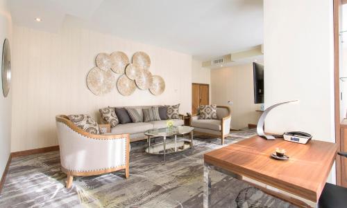 a living room with a couch and a table at Landmark Amman Hotel & Conference Center in Amman