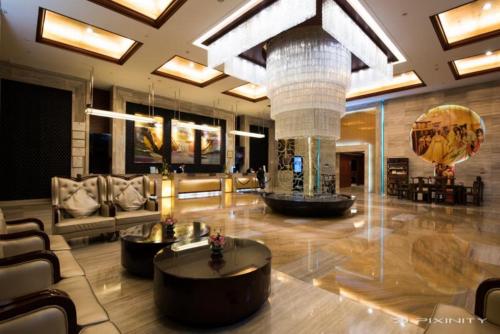 a lobby with a couch and a table in a building at Grand Mercure Xiamen Downtown-Free Welcome Fruit & Metro Station in Xiamen