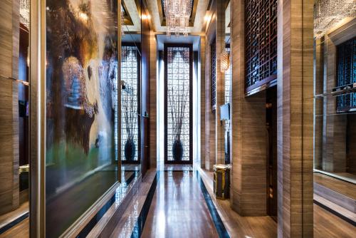a hallway in a museum with a painting on the wall at Grand Mercure Xiamen Downtown-Free Welcome Fruit & Metro Station in Xiamen