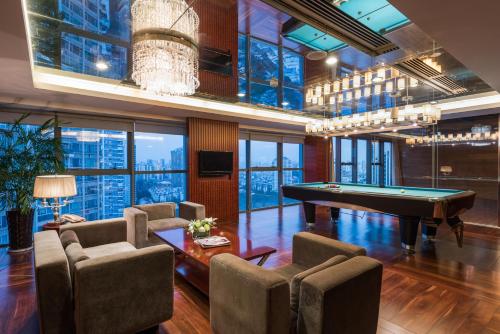 a billiard room with a pool table and chairs at Grand Mercure Xiamen Downtown-Free Welcome Fruit & Metro Station in Xiamen