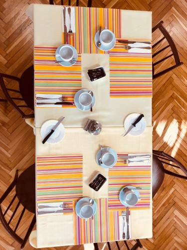 a table with plates and utensils on it at Hotel Slatina in Lipova Lazne